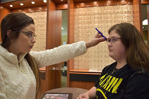 Students practice fitting eyeglasses in the Roane State Vision Clinic.