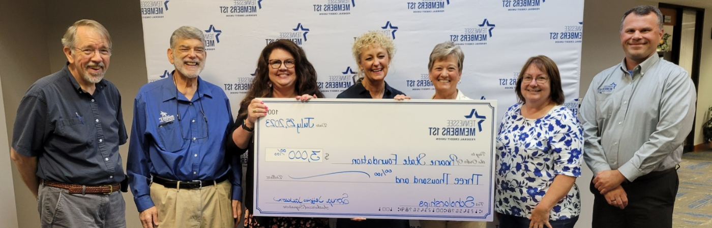 A group of people holding a check.